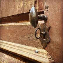 Antika beslag från olika håll möts i gammal återbrukad dörr